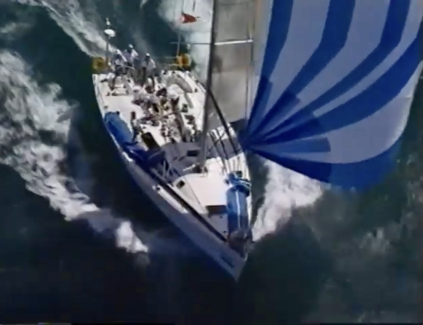 Warrior from above with a blue and white spinnaker