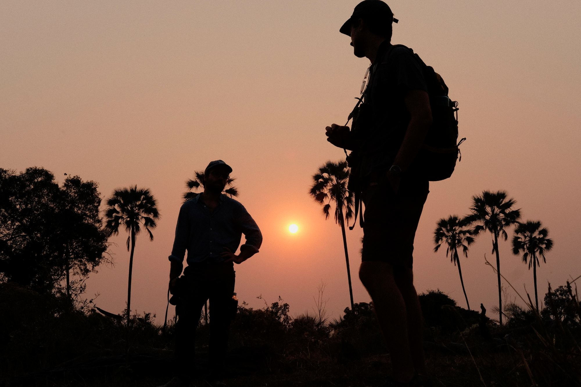Guides silhouetted against the setting sun